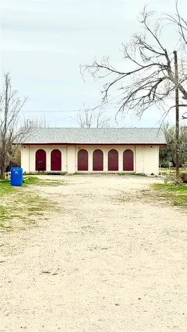 a big white house with large windows and a big yard