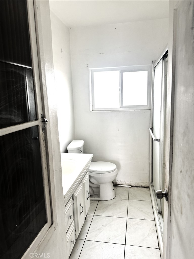 19859 Anahola Road Barstow, CA 92311 - Photo 6 of 14 a bathroom with a toilet and a shower