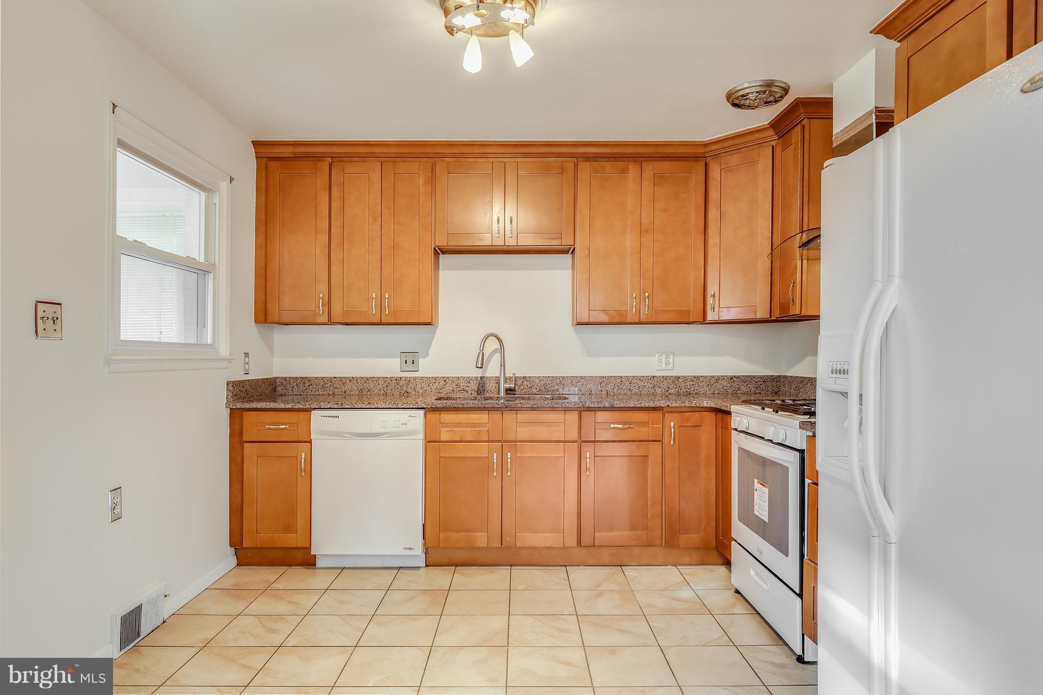7515 Gresham Street Springfield, VA 22151 - Photo 11 of 36 a kitchen with stainless steel appliances granite countertop a sink and cabinets