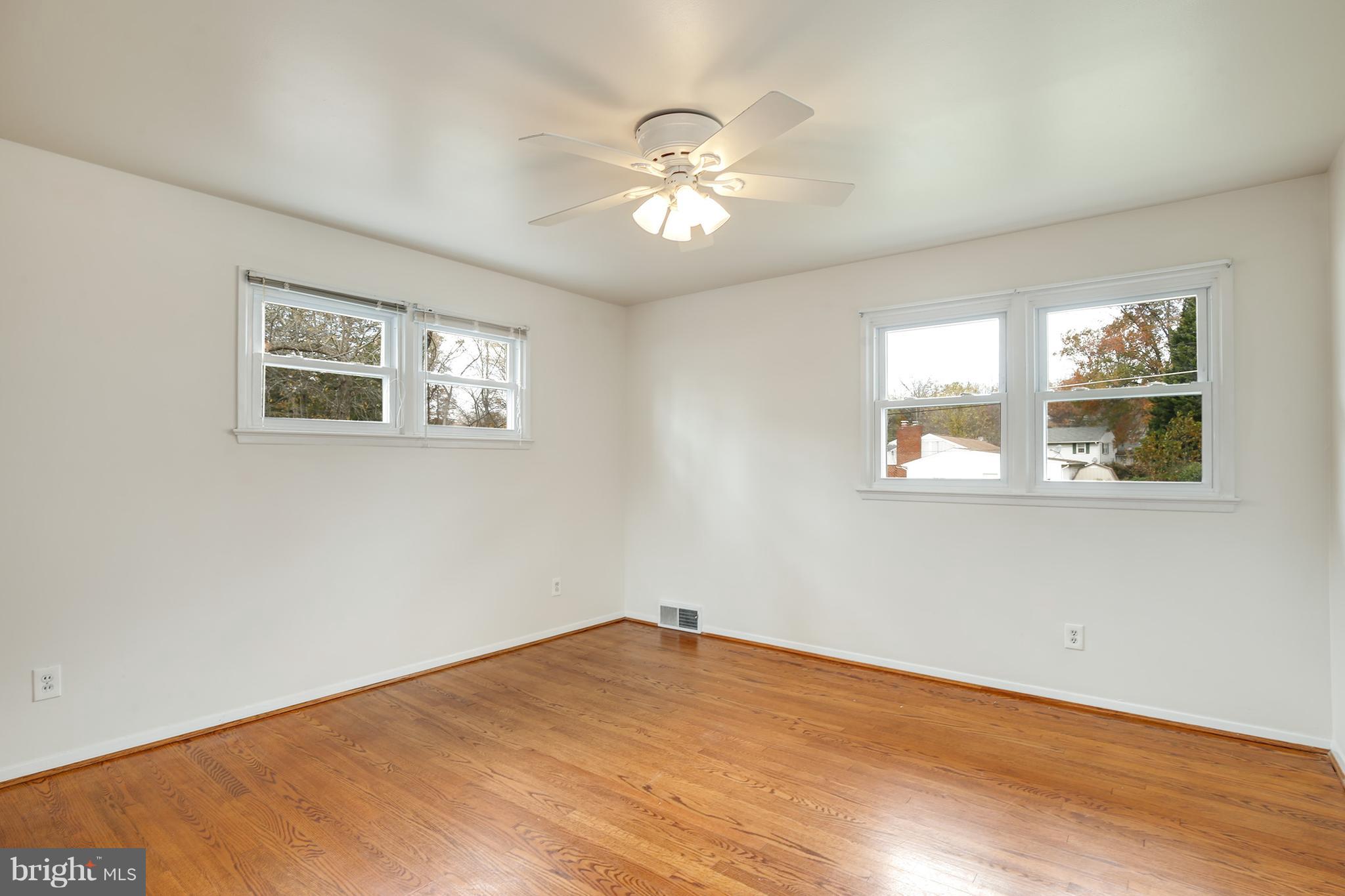7515 Gresham Street Springfield, VA 22151 - Photo 15 of 36 a view of an empty room with wooden floor and a window