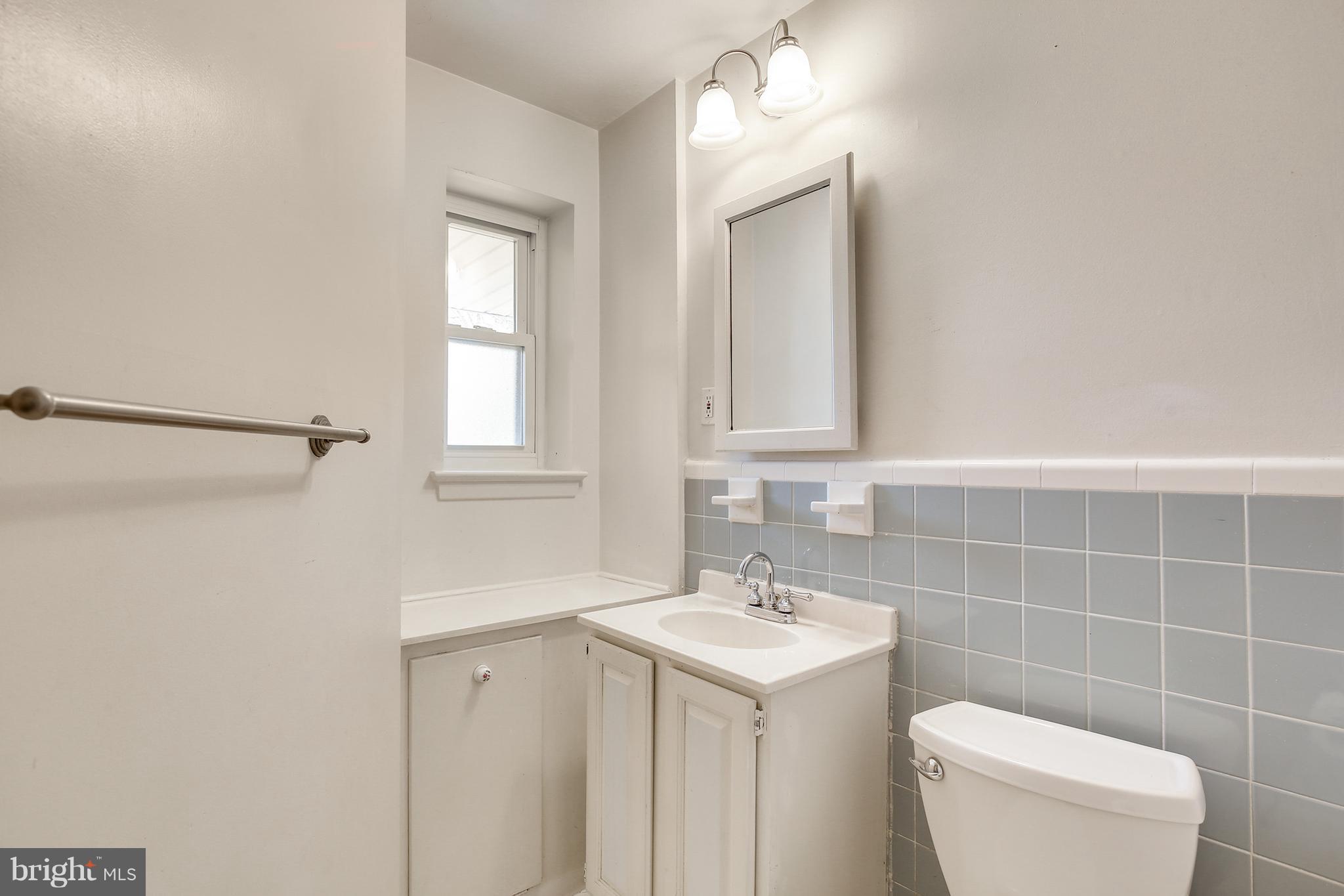 7515 Gresham Street Springfield, VA 22151 - Photo 22 of 36 a bathroom with a toilet sink and mirror