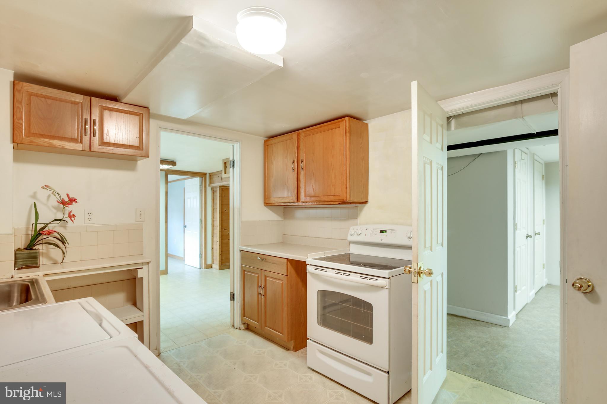 7515 Gresham Street Springfield, VA 22151 - Photo 31 of 36 a kitchen with stainless steel appliances granite countertop a stove and a sink