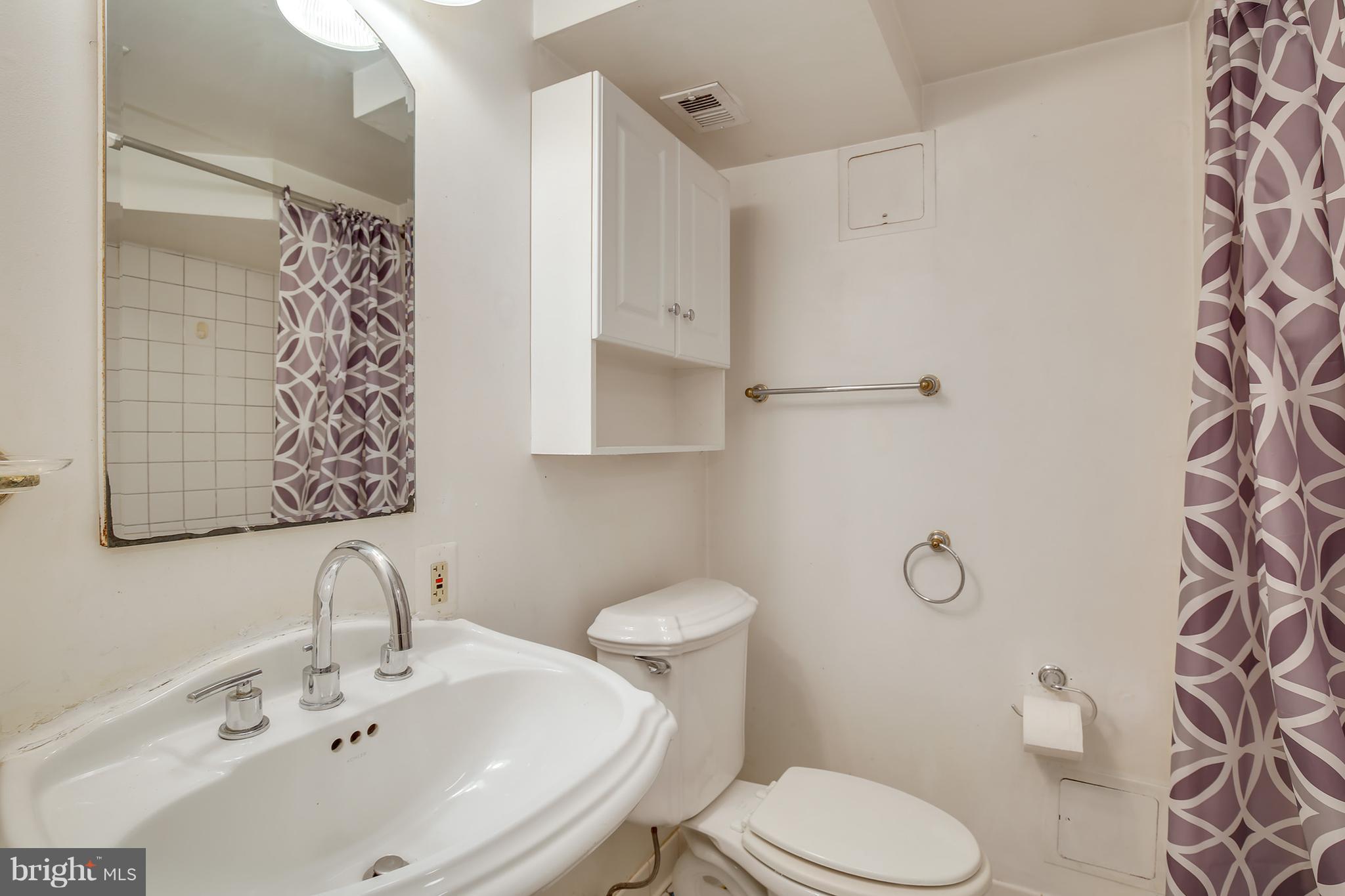 7515 Gresham Street Springfield, VA 22151 - Photo 33 of 36 a bathroom with a sink toilet and shower