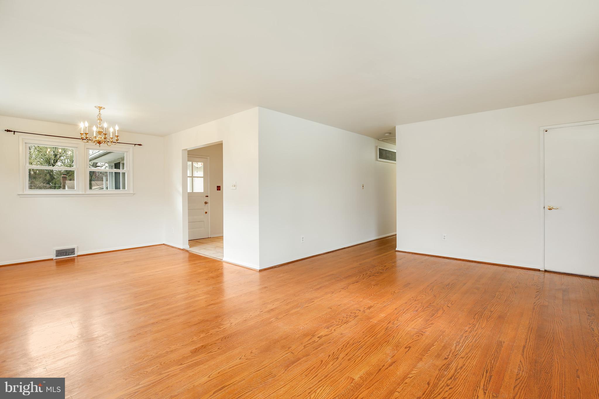 7515 Gresham Street Springfield, VA 22151 - Photo 6 of 36 a view of an empty room with wooden floor and a window