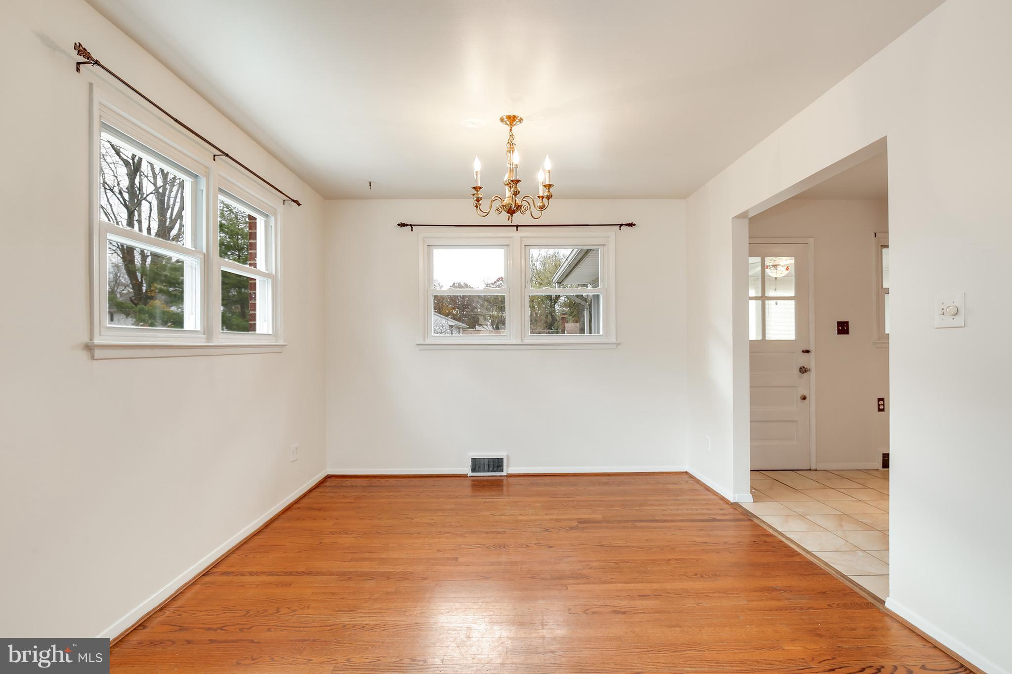 7515 Gresham Street Springfield, VA 22151 - Photo 7 of 36 a view of empty room with wooden floor and window