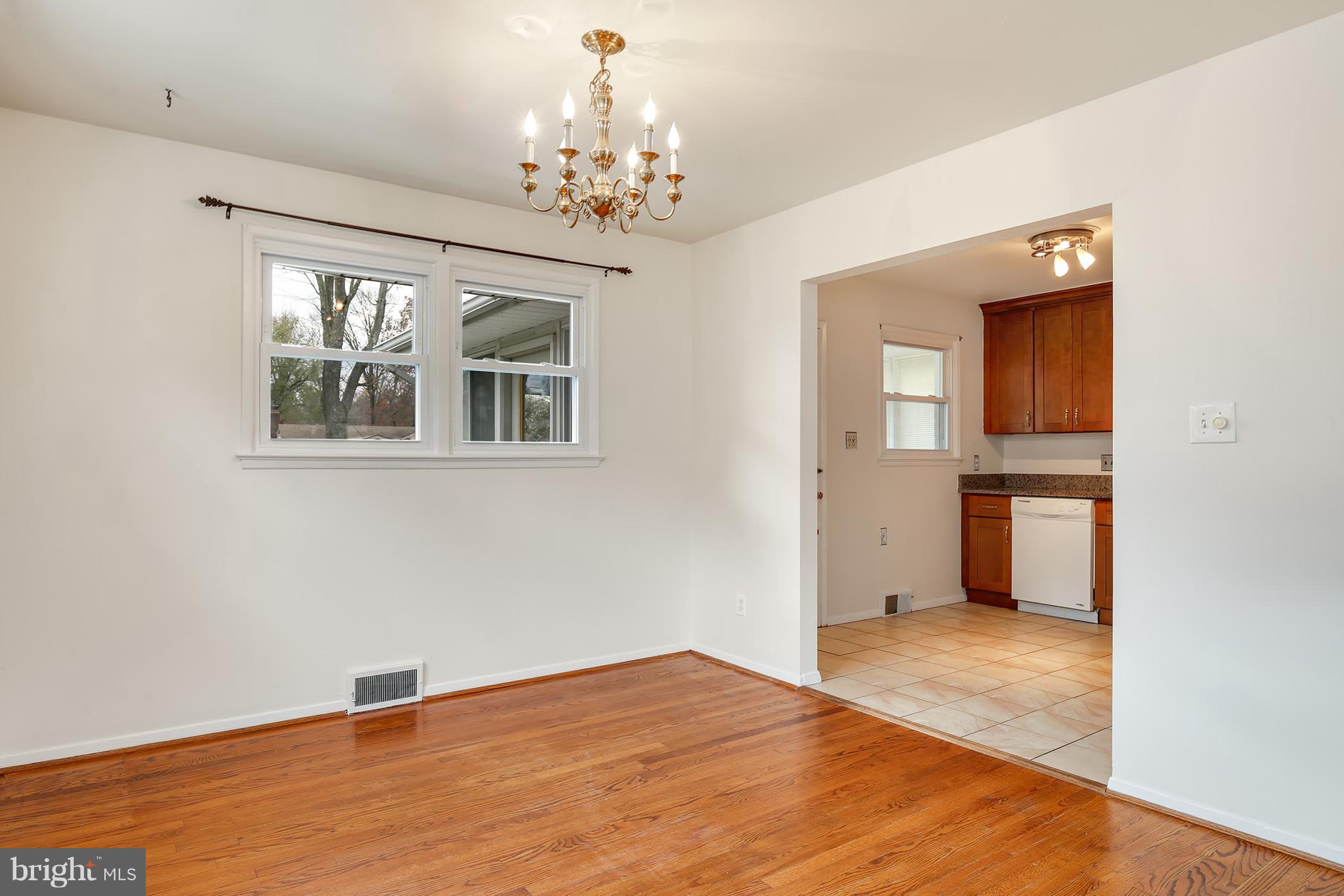 7515 Gresham Street Springfield, VA 22151 - Photo 8 of 36 a view of an empty room with wooden floor and a window