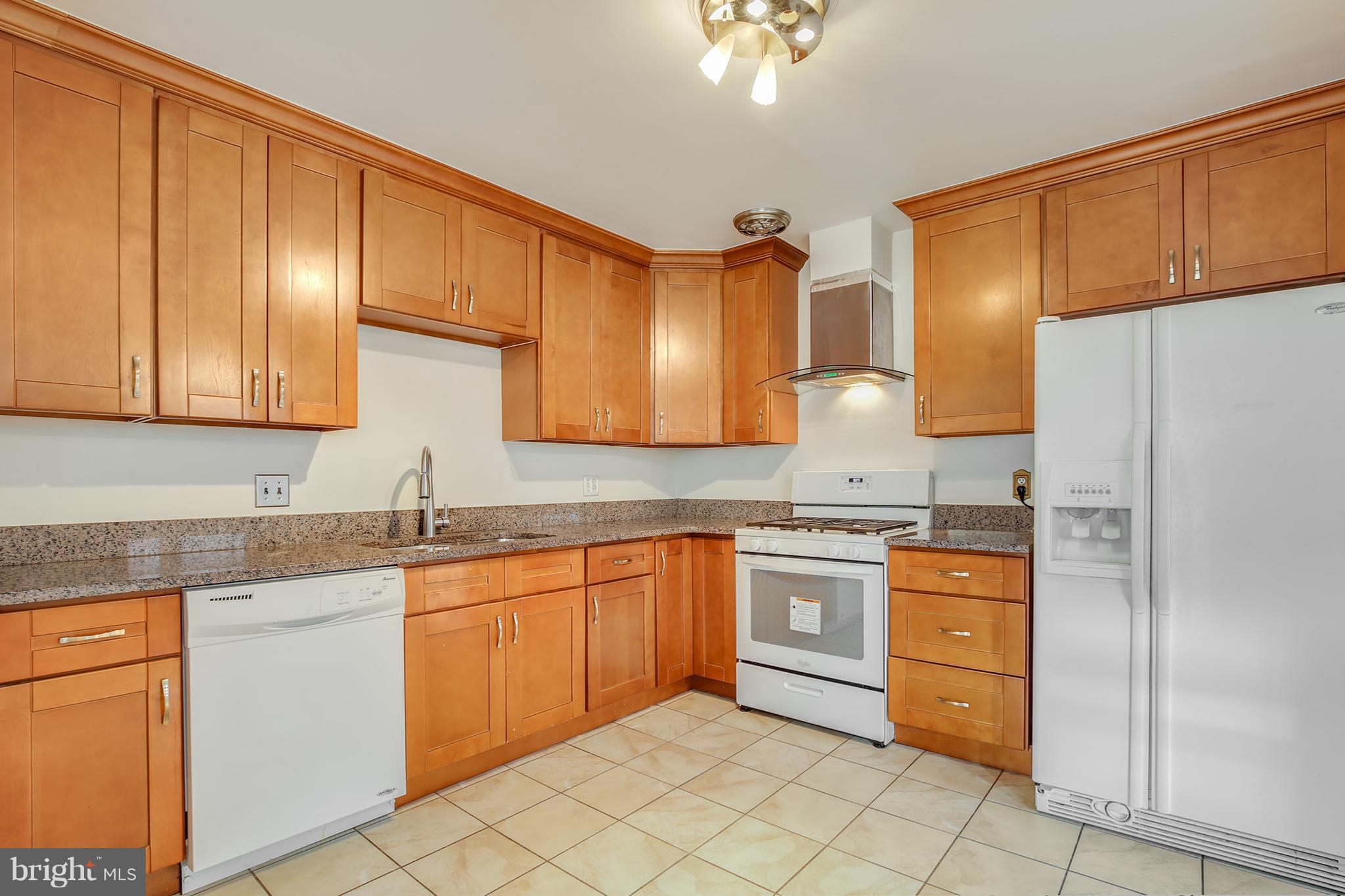 7515 Gresham Street Springfield, VA 22151 - Photo 9 of 36 a kitchen with stainless steel appliances granite countertop a sink stove and refrigerator