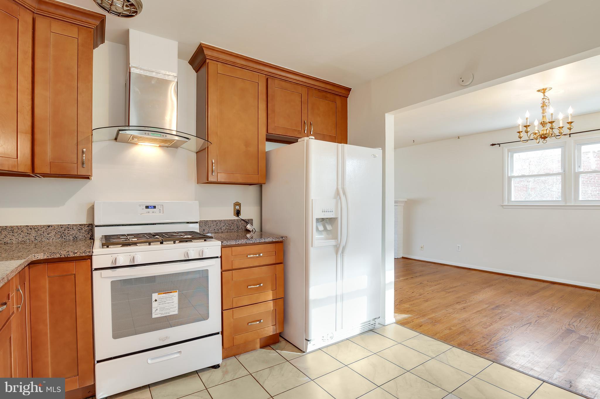 7515 Gresham Street Springfield, VA 22151 - Photo 10 of 36 a kitchen with a stove a refrigerator and cabinets
