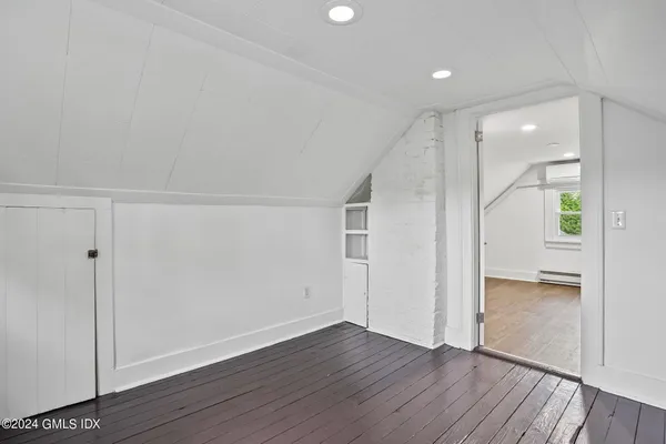 a view of an empty room and wooden floor