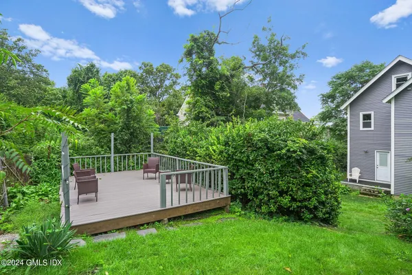 a view of a chair and table in the garden