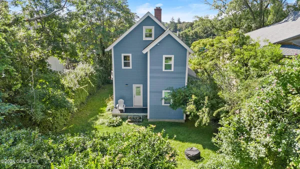 a view of a house with a yard and garden