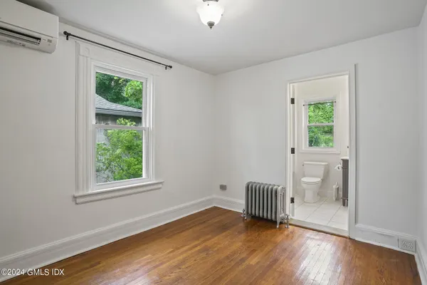 a view of wooden floor and windows in a room