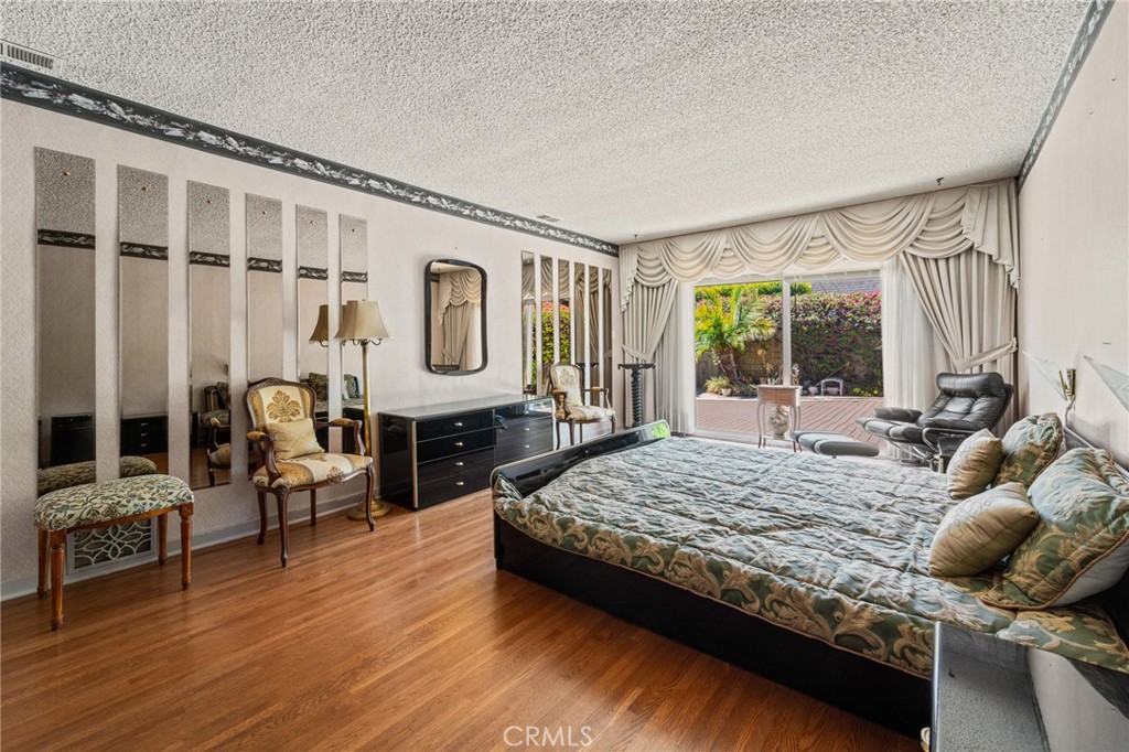 233 South Swall Drive Beverly Hills, CA 90211 - Photo 15 of 28 a bedroom with a bed and wooden floor