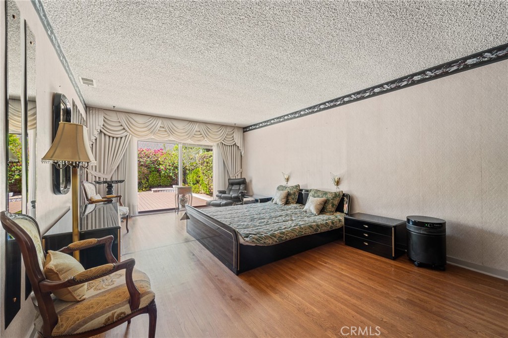 233 South Swall Drive Beverly Hills, CA 90211 - Photo 16 of 28 a bedroom with furniture and a wooden floor