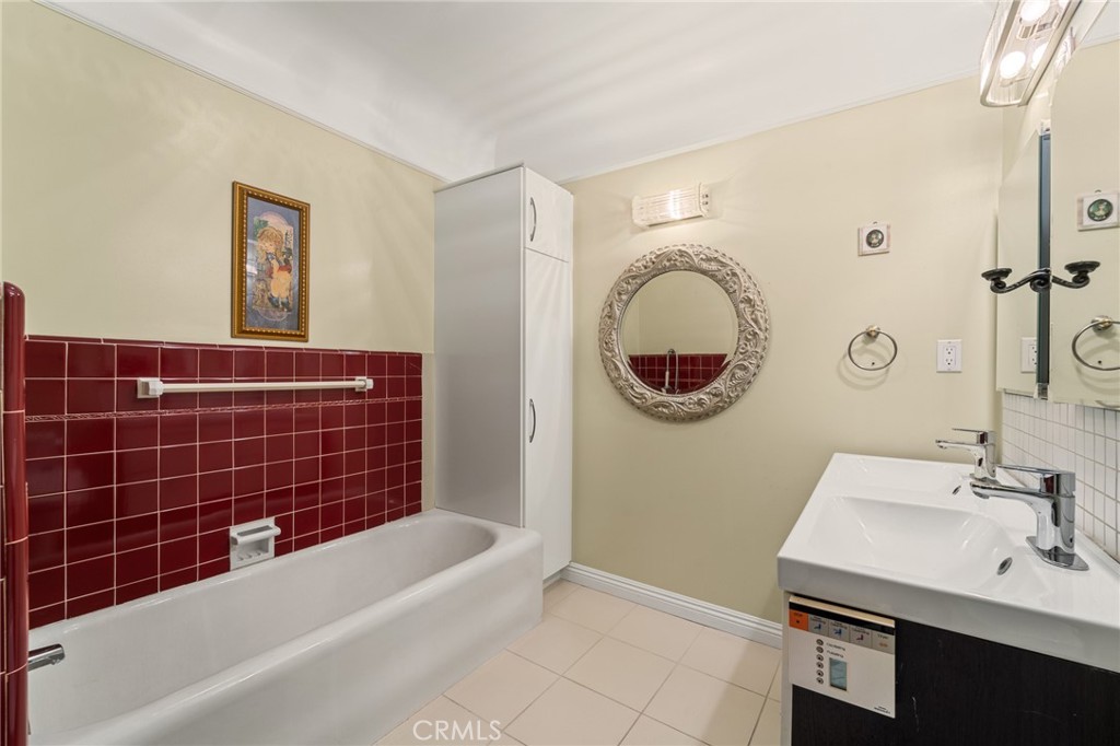 233 South Swall Drive Beverly Hills, CA 90211 - Photo 17 of 28 a bathroom with a bath tub a sink and mirror