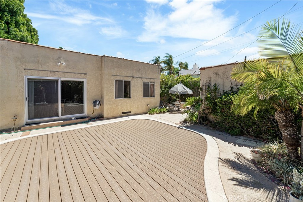 233 South Swall Drive Beverly Hills, CA 90211 - Photo 28 of 28 a house with yard and trees in front of it