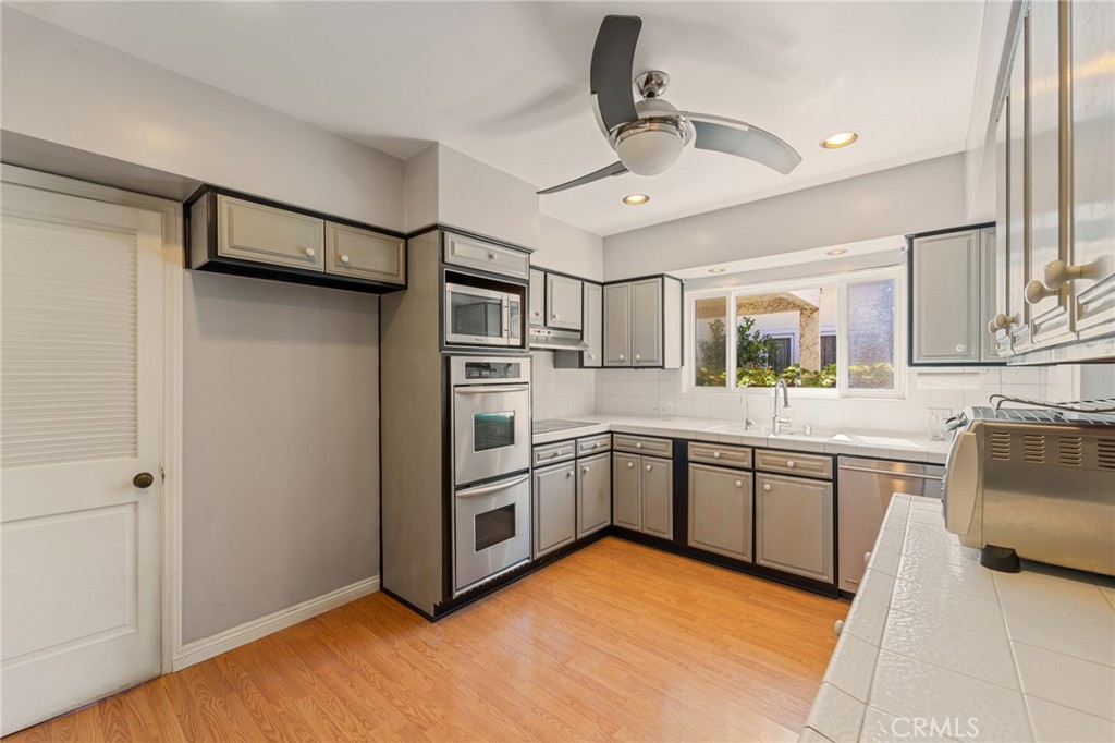 233 South Swall Drive Beverly Hills, CA 90211 - Photo 6 of 28 a kitchen with stainless steel appliances granite countertop a refrigerator and a sink