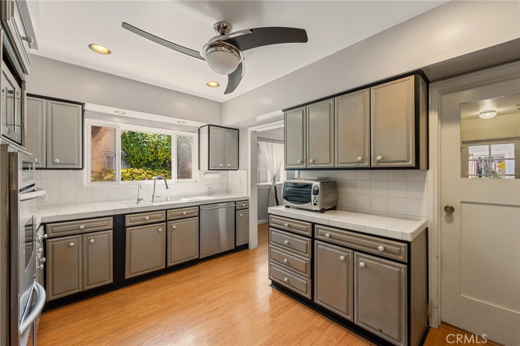 233 South Swall Drive Beverly Hills, CA 90211 - Photo 7 of 28 a kitchen with a sink cabinets and window