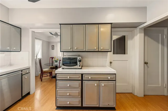 a kitchen with stainless steel appliances a stove a sink and cabinets