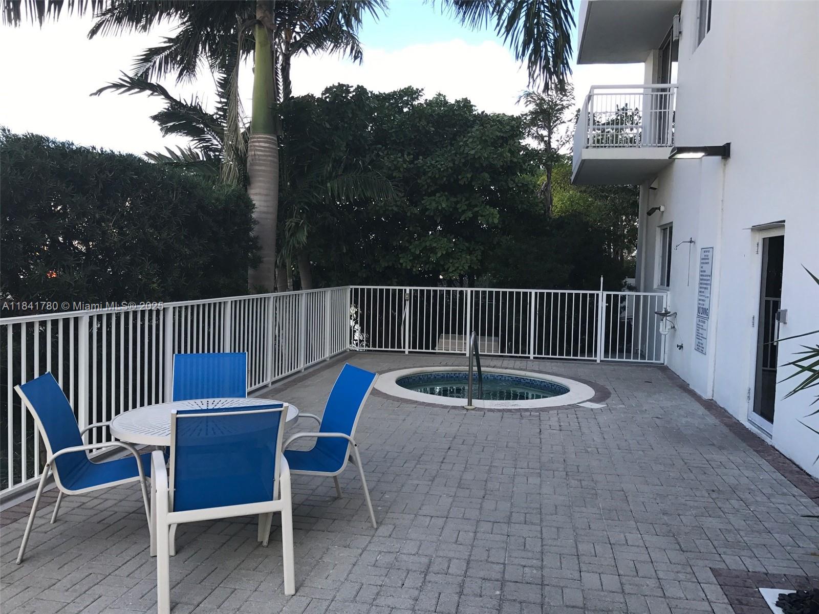 1688 West Avenue, Unit 1005 Miami Beach, FL 33139 - Photo 20 of 34 a backyard of a house with table and chairs