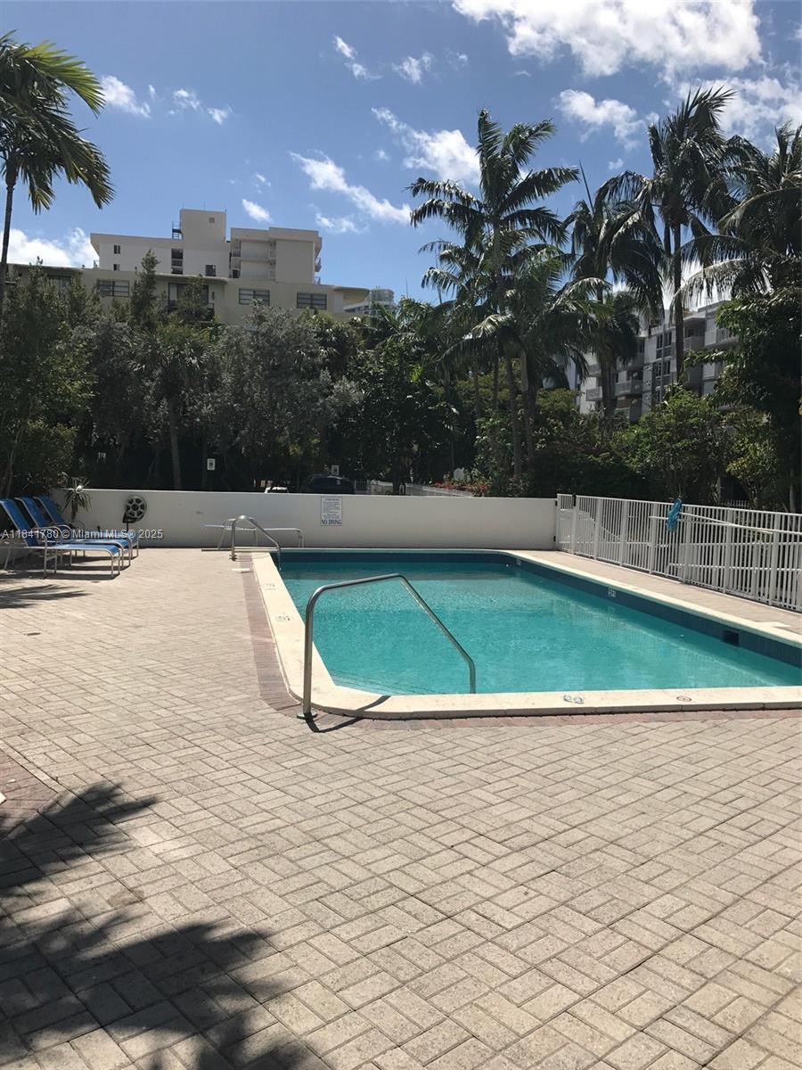 1688 West Avenue, Unit 1005 Miami Beach, FL 33139 - Photo 21 of 34 a view of a swimming pool with a yard