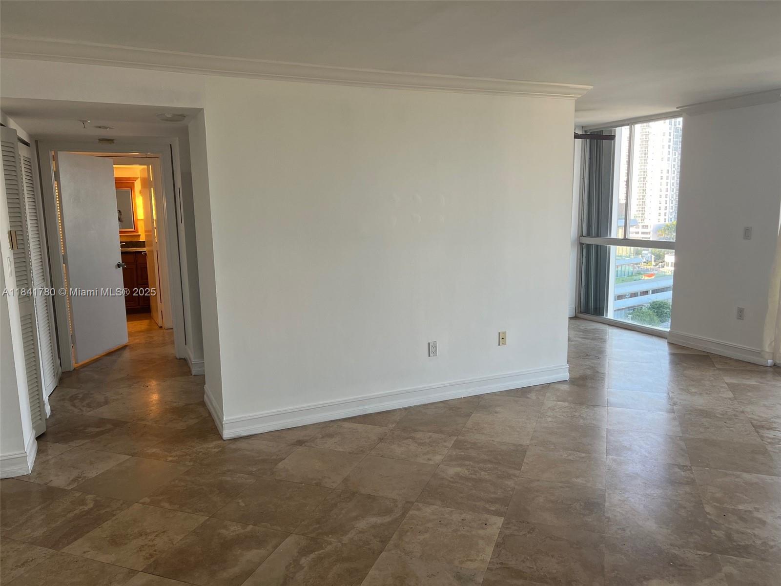 1688 West Avenue, Unit 1005 Miami Beach, FL 33139 - Photo 9 of 34 an empty room with wooden floor and windows