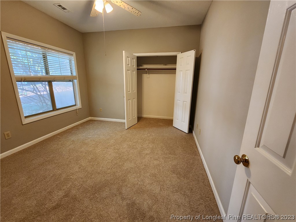 6111 Sunpointe Drive, Unit 104 Raleigh, NC 27606 - Photo 23 of 49 an empty room with windows and entrance