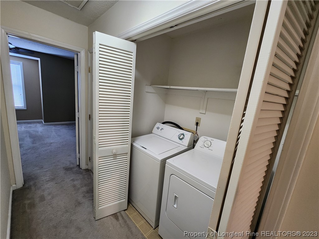6111 Sunpointe Drive, Unit 104 Raleigh, NC 27606 - Photo 36 of 49 a utility room with dryer and washer