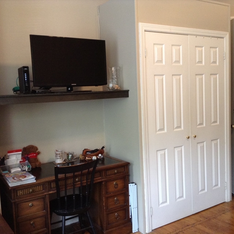 16 Cumberland Street, Unit 1 Boston, MA 02115 - Photo 3 of 8 a view of a workspace with furniture