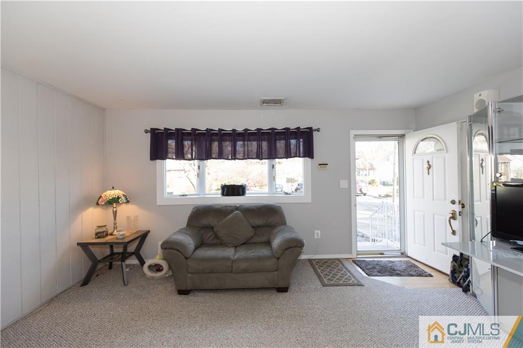 205 North Hill Road Colonia, NJ 07067 - Photo 11 of 25 a living room with furniture and a flat screen tv