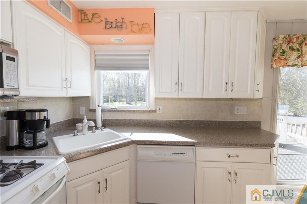 205 North Hill Road Colonia, NJ 07067 - Photo 12 of 25 a kitchen with appliances cabinets and a window