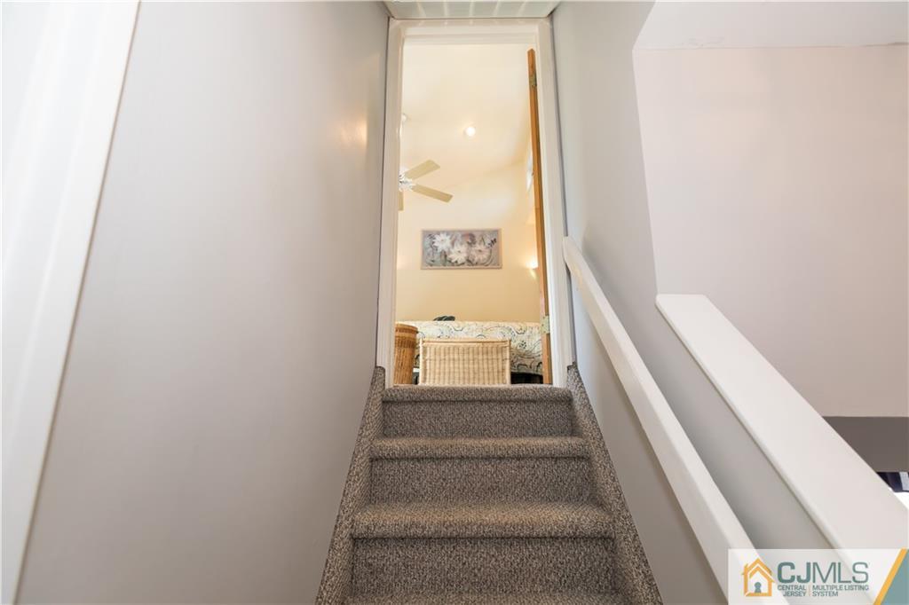 205 North Hill Road Colonia, NJ 07067 - Photo 17 of 25 a view of a hallway with wooden floor and staircase