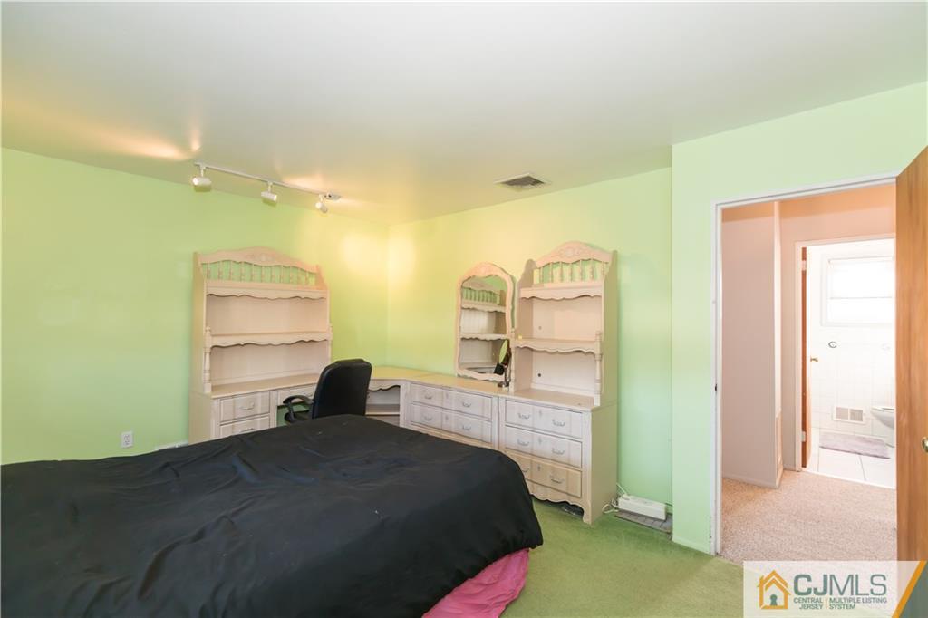 205 North Hill Road Colonia, NJ 07067 - Photo 20 of 25 a bedroom with a bed and a painting on the wall
