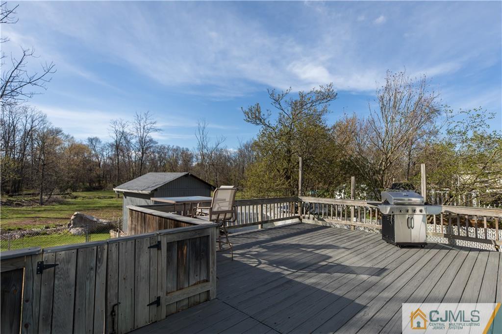 205 North Hill Road Colonia, NJ 07067 - Photo 8 of 25 a view of a deck with wooden floor and barbeque oven