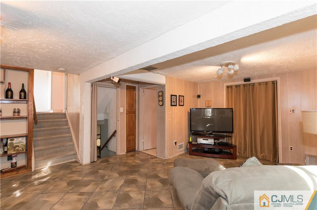 205 North Hill Road Colonia, NJ 07067 - Photo 9 of 25 a room with a bed a television and a large window