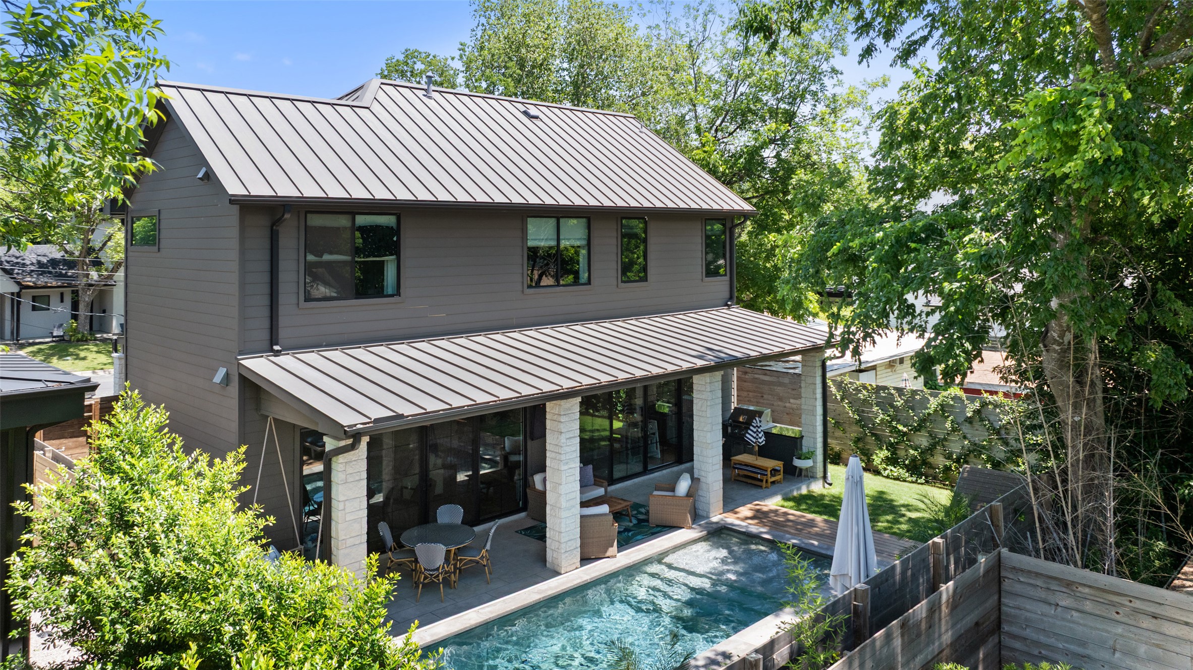 2107 Peach Tree Street Austin, TX 78704 - Photo 1 of 40 Back of property with a standing seam roof, metal roof, and a patio area