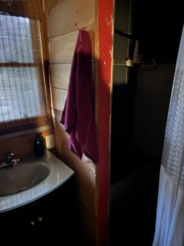 a bedroom with a bed and a mirror