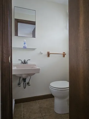 a bathroom with a sink toilet and a mirror