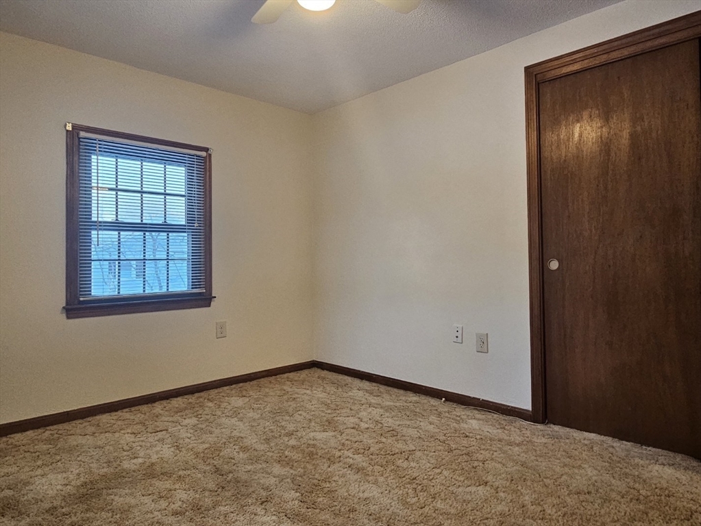 27 Summer Street, Unit 27 Chelmsford, MA 01824 - Photo 8 of 15 an empty room with a empty space and windows