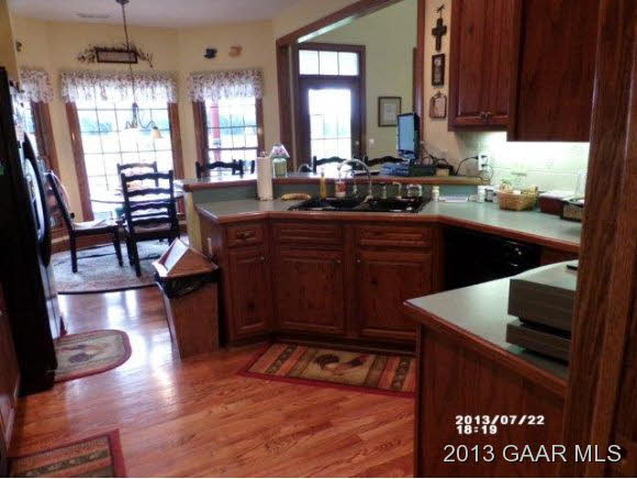 1400 Hermitage Road Waynesboro, VA 22980 - Photo 5 of 23 a kitchen with stainless steel appliances granite countertop a refrigerator a sink dishwasher a stove and white countertops with wooden floor