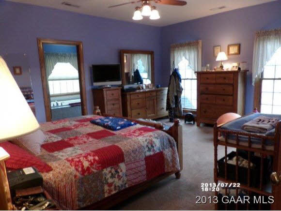 1400 Hermitage Road Waynesboro, VA 22980 - Photo 8 of 23 a bedroom with a bed a chandelier and dresser