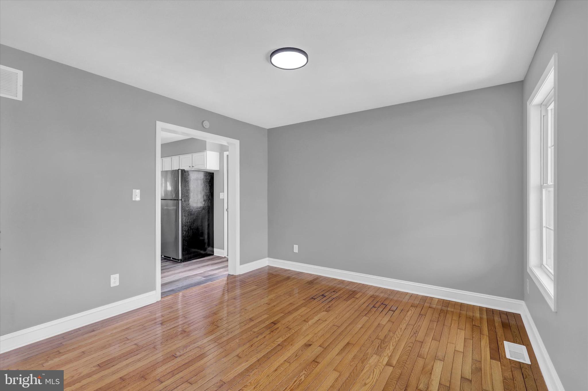 195 St Johns Road West Littlestown, PA 17340 - Photo 3 of 36 a view of an empty room with wooden floor and a window