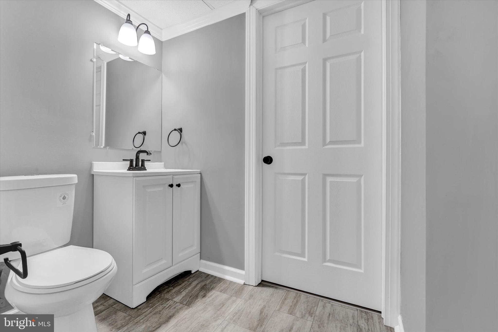 195 St Johns Road West Littlestown, PA 17340 - Photo 32 of 36 a bathroom with a toilet a sink and mirror