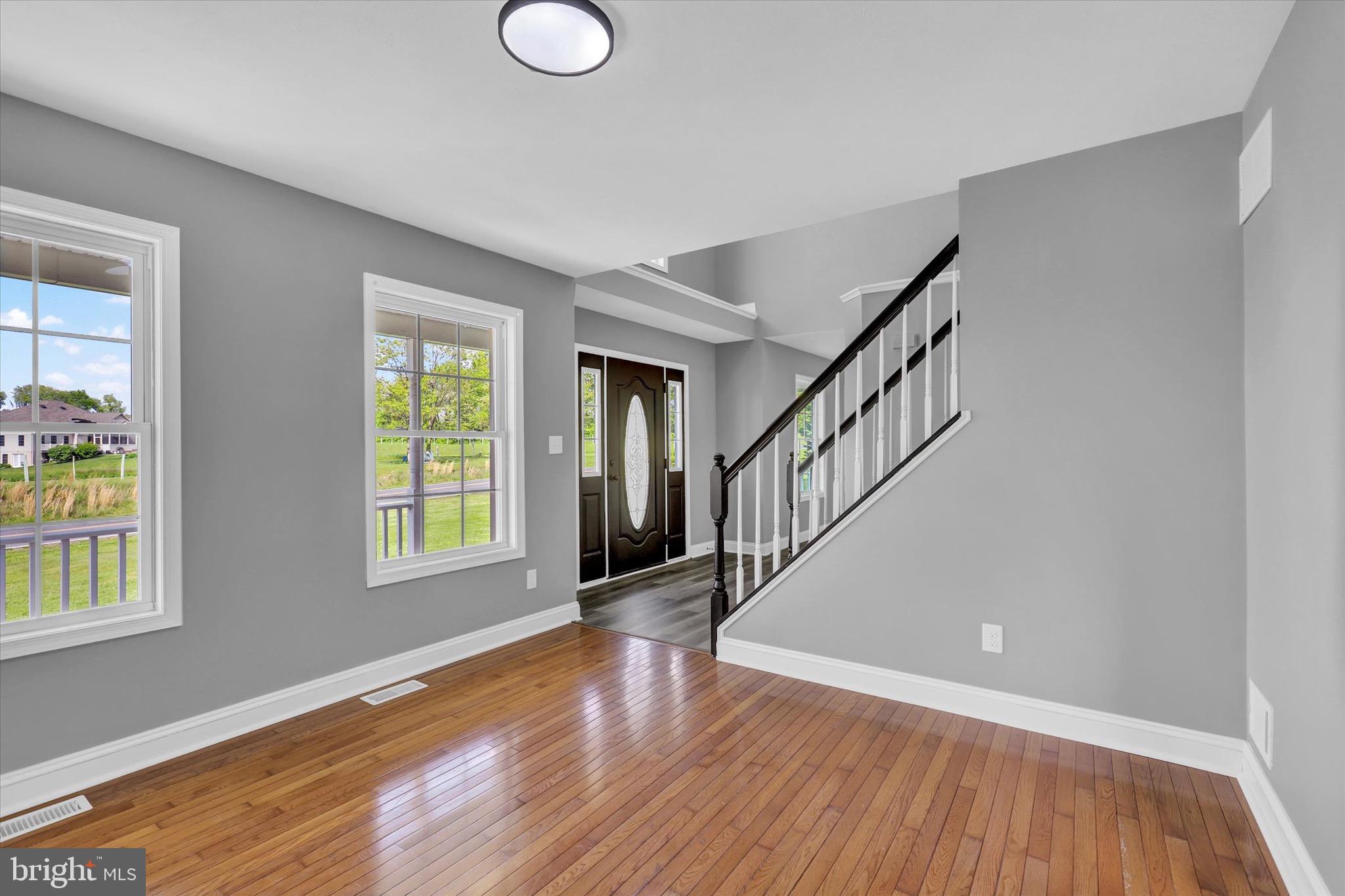 195 St Johns Road West Littlestown, PA 17340 - Photo 4 of 36 a view of an empty room with wooden floor and a window