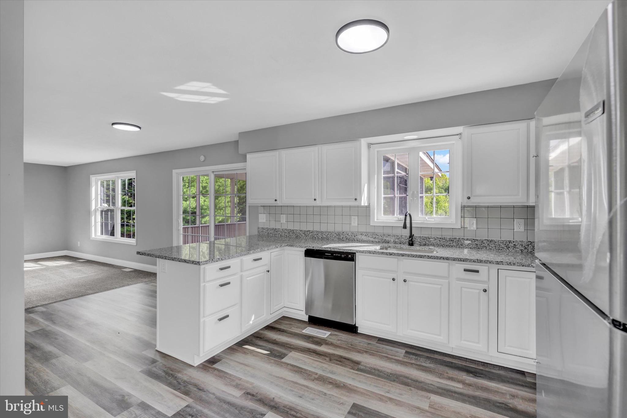 195 St Johns Road West Littlestown, PA 17340 - Photo 5 of 36 a kitchen with granite countertop white cabinets and white appliances