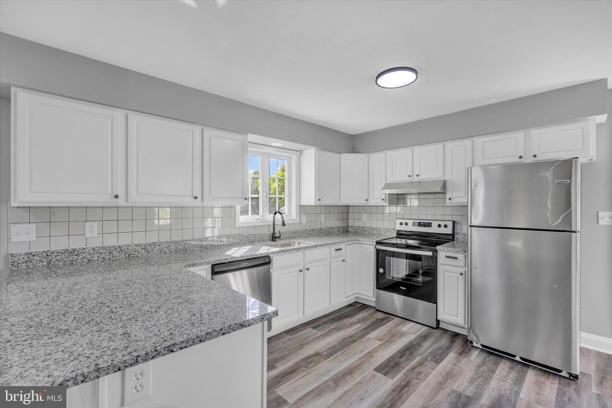 195 St Johns Road West Littlestown, PA 17340 - Photo 6 of 36 a kitchen with stainless steel appliances granite countertop a sink stove and refrigerator