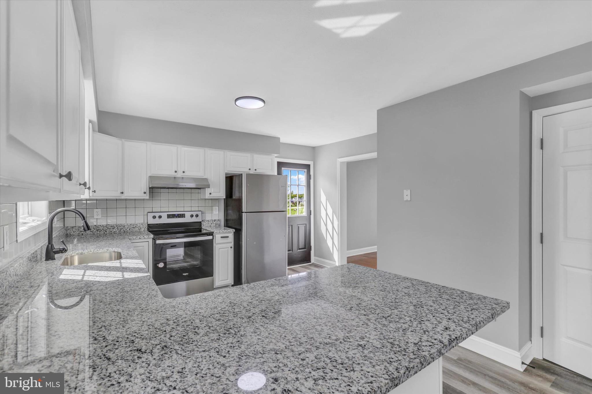 195 St Johns Road West Littlestown, PA 17340 - Photo 7 of 36 a kitchen with stainless steel appliances granite countertop a refrigerator and a sink