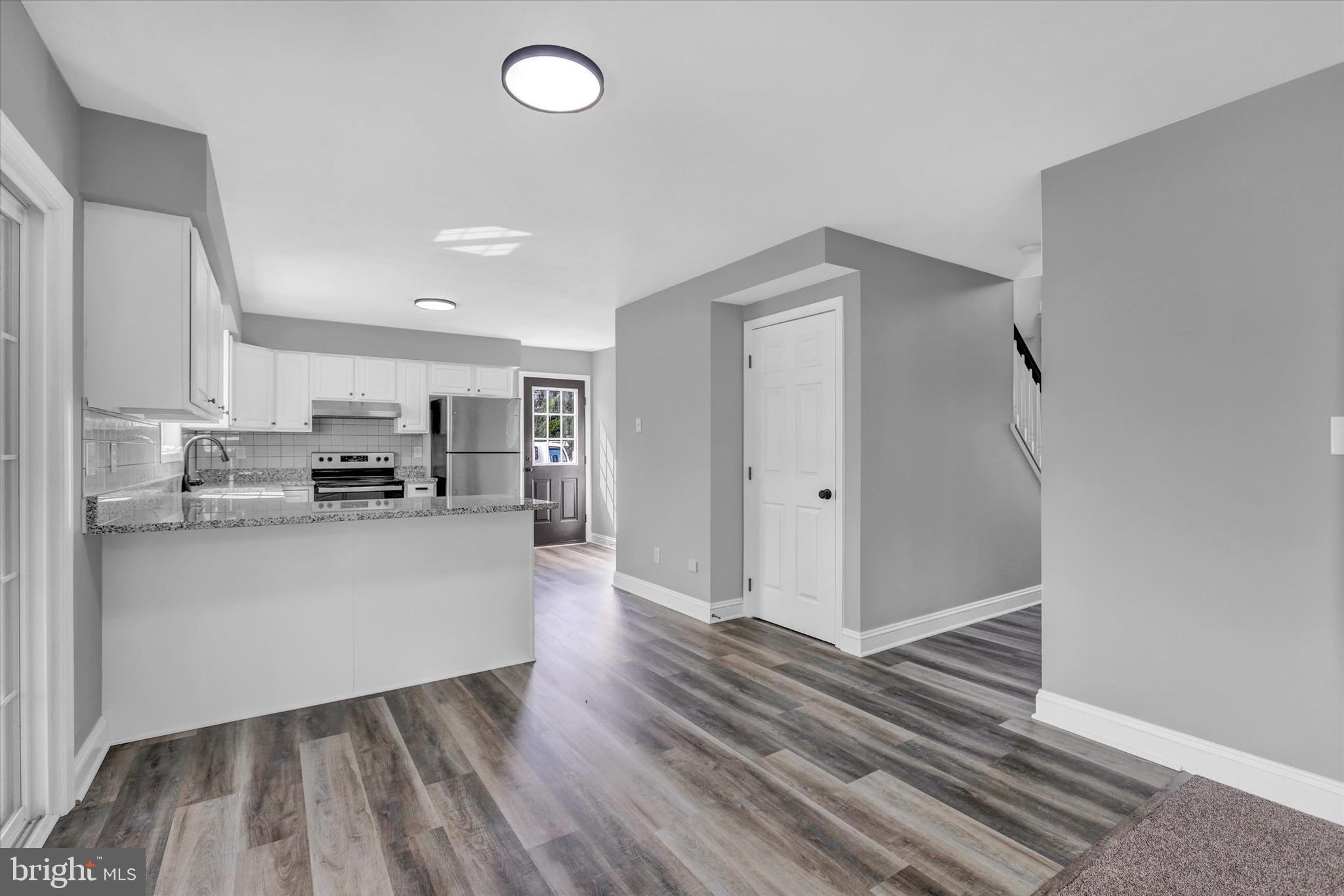 195 St Johns Road West Littlestown, PA 17340 - Photo 8 of 36 a kitchen with stainless steel appliances granite countertop a refrigerator and a stove top oven