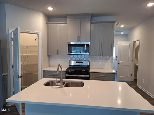 a kitchen with a sink and a refrigerator
