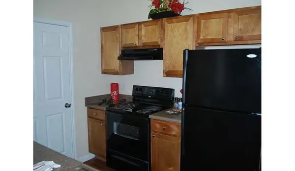 a kitchen with stainless steel appliances granite countertop a refrigerator and a stove
